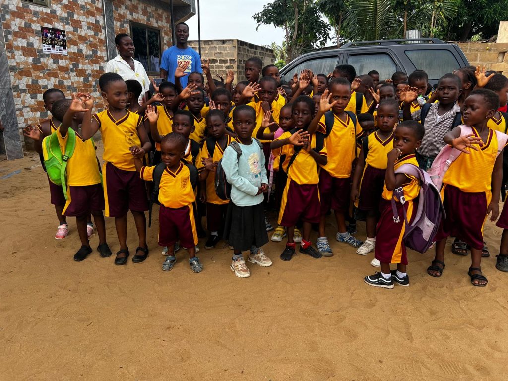 Pupils in house colours gathered outdoors at Rayliza Academy